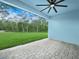 A spacious outdoor patio area features pavers and beautiful green backyard view at 527 Rio Grande Dr, Poinciana, FL 34759