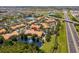 This aerial showcases the community's serene setting, with a pond and lush greenery against a highway backdrop at 5467 Vineland Rd # 6110, Orlando, FL 32811