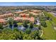 Stunning aerial view of the property featuring a tranquil lake and meticulously manicured landscaping at 5467 Vineland Rd # 6110, Orlando, FL 32811