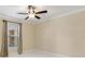 Comfortable bedroom with bright white floors and large window with blinds at 5467 Vineland Rd # 6110, Orlando, FL 32811