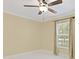 Well-lit bedroom features bright white floors, neutral walls, and a large window with coverings at 5467 Vineland Rd # 6110, Orlando, FL 32811