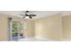 Inviting bedroom with bright floors and a sliding glass door to the outdoors at 5467 Vineland Rd # 6110, Orlando, FL 32811