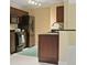 Modern kitchen with stainless steel appliances, dark wood cabinets, stylish fixtures, and complementary colored accent rug at 5467 Vineland Rd # 6110, Orlando, FL 32811
