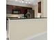 Bright kitchen featuring granite countertops, stainless steel sink, and dark wood cabinets at 5467 Vineland Rd # 6110, Orlando, FL 32811