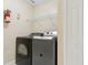 Convenient laundry room features a full-size washer and dryer with built-in shelving at 5467 Vineland Rd # 6110, Orlando, FL 32811