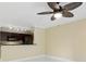 Open concept living room with bright white floors, neutral walls, and a view of the modern kitchen at 5467 Vineland Rd # 6110, Orlando, FL 32811