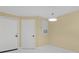 Bright, airy living room featuring crisp white tile floors, neutral paint, modern lighting fixtures, and ample natural light at 5467 Vineland Rd # 6110, Orlando, FL 32811
