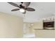 Bright and airy living room featuring a ceiling fan and a view of the kitchen at 5467 Vineland Rd # 6110, Orlando, FL 32811