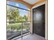 Screened patio offers a tranquil view of the lush greenery and landscaped grounds at 5467 Vineland Rd # 6110, Orlando, FL 32811