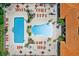 Aerial view of a community pool area with a large pool and an adjacent kiddie pool surrounded by chairs at 5467 Vineland Rd # 6110, Orlando, FL 32811