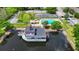 Aerial view of lake and community pool featuring gazebo, tennis court, and mature landscaping at 6052 Village Cir # 6052, Orlando, FL 32822