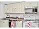 Kitchen featuring modern appliances and cabinetry with ample countertop space at 6052 Village Cir # 6052, Orlando, FL 32822