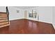 Open living room featuring wood floors and a staircase leading to the upper level at 6052 Village Cir # 6052, Orlando, FL 32822