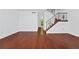 Bright and open living room featuring wood floors and a staircase at 6052 Village Cir # 6052, Orlando, FL 32822