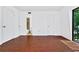 Bright bedroom with wood floors, walk-in closet, and sliding glass doors to a balcony at 6052 Village Cir # 6052, Orlando, FL 32822