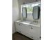 Elegant bathroom featuring a double sink vanity with white cabinets and brushed nickel hardware at 611 Amazon Pl, Kissimmee, FL 34759
