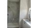 Modern bathroom with a tiled walk-in shower and single sink vanity with brushed nickel hardware at 611 Amazon Pl, Kissimmee, FL 34759