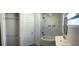Well-lit bathroom with marble tiled shower and tub, complemented by a sleek vanity at 611 Amazon Pl, Kissimmee, FL 34759