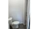 Simple half-bath with modern toilet, and a glimpse of shelving through an open door at 611 Amazon Pl, Kissimmee, FL 34759
