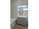 Bathroom featuring a new vanity, tub and modern finishes with a window for natural light at 611 Amazon Pl, Kissimmee, FL 34759