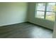 Bright bedroom with hardwood floors and a large window providing natural light at 611 Amazon Pl, Kissimmee, FL 34759