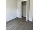 Bedroom featuring gray flooring and a closet with folding doors, offering convenient storage at 611 Amazon Pl, Kissimmee, FL 34759