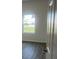 Bright bedroom with a neutral color palette and wood-look flooring, featuring a large window at 611 Amazon Pl, Kissimmee, FL 34759