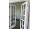 Elegant French doors with glass panels lead into a bright and inviting room at 611 Amazon Pl, Kissimmee, FL 34759