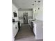 Modern kitchen with white cabinets, stainless steel appliances, and a large center island at 611 Amazon Pl, Kissimmee, FL 34759