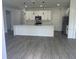 Spacious kitchen with white cabinetry, quartz countertops, and stainless steel appliances at 611 Amazon Pl, Kissimmee, FL 34759