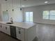 Open concept kitchen with a large island, stainless steel appliances, and seamless access to living area at 611 Amazon Pl, Kissimmee, FL 34759