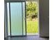 Sliding glass door providing access to the backyard and natural light into the room at 611 Amazon Pl, Kissimmee, FL 34759