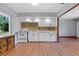 Renovated kitchen featuring white cabinets, a mosaic backsplash, and modern appliances at 641 Jackson St, Eustis, FL 32726