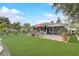 Large backyard with green lawn and outdoor seating, perfect for enjoying outdoor activities and relaxation at 840 Del Prado Dr, Kissimmee, FL 34758