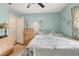 This bedroom offers tile flooring, light blue walls, a ceiling fan, and a view of the window at 840 Del Prado Dr, Kissimmee, FL 34758