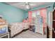 Cozy bedroom featuring light blue walls, a ceiling fan, and a window with pink curtains at 840 Del Prado Dr, Kissimmee, FL 34758