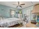This bedroom has light blue walls and tile flooring, with an exercise bike and mounted TV at 840 Del Prado Dr, Kissimmee, FL 34758