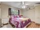Bedroom showcasing tile floors, a ceiling fan, and a dresser near the window at 840 Del Prado Dr, Kissimmee, FL 34758