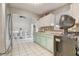 Efficient kitchen with tile flooring, updated cabinets, and a view into the adjacent dining area at 840 Del Prado Dr, Kissimmee, FL 34758