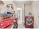 Laundry room view featuring red washer and dryer with laundry supplies nearby at 840 Del Prado Dr, Kissimmee, FL 34758