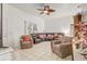 Inviting living room with tile floors, neutral walls, cozy seating, and ample natural light from windows at 840 Del Prado Dr, Kissimmee, FL 34758