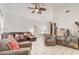 Spacious living room with comfortable seating, tile flooring, and a view into the dining area at 840 Del Prado Dr, Kissimmee, FL 34758