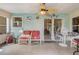 Inviting sunroom featuring tiled floors, a ceiling fan, and comfortable wicker seating at 840 Del Prado Dr, Kissimmee, FL 34758