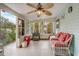 Cozy sunroom with light walls, tiled floor, and wicker furniture, perfect for relaxation at 840 Del Prado Dr, Kissimmee, FL 34758