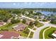 Aerial view of a home with yellow property lines, lush landscaping, and a nearby lake at 8988 Angelica Dr, Orlando, FL 32836