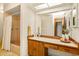 Bathroom featuring a shower/tub combo, and wood vanity with large mirror at 8988 Angelica Dr, Orlando, FL 32836