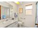 Bright bathroom features a sink, toilet, shower and a window at 8988 Angelica Dr, Orlando, FL 32836