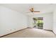 Empty bedroom featuring neutral carpet, ceiling fan, and sliding glass doors at 8988 Angelica Dr, Orlando, FL 32836
