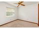 Empty carpeted bedroom with a window and ceiling fan at 8988 Angelica Dr, Orlando, FL 32836