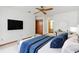 Cozy bedroom featuring a ceiling fan, TV, and en-suite bathroom access at 8988 Angelica Dr, Orlando, FL 32836